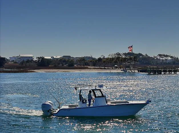 Slide: The Image of Freeman 28 boat cruising on sparkling water near a scenic shoreline, 2024 model. - 9