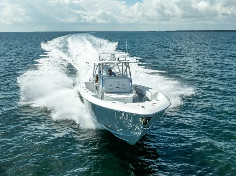 Slide: The Image of 2025 Contender 44 ST boat cruising on open water, leaving a wake behind. - 10