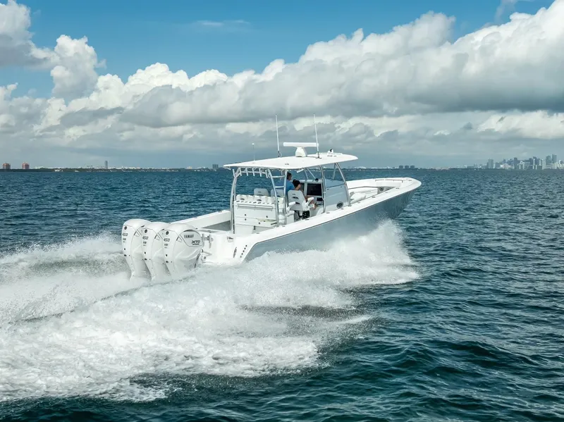 Slide: The Image of 2025 Contender 44 ST boat cruising on open water under a cloudy sky. - 11