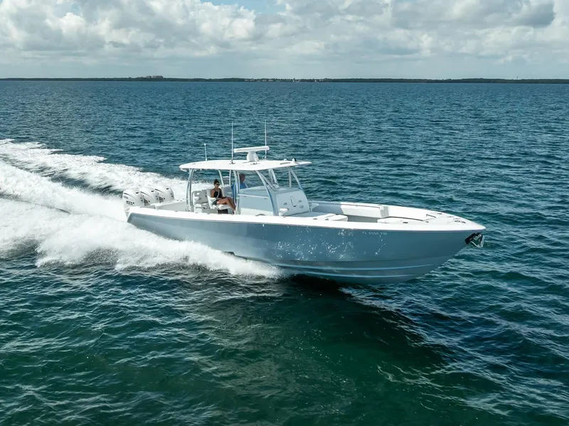 Slide: The Image of 2025 Contender 44 ST boat cruising on open water under a cloudy sky. - 16