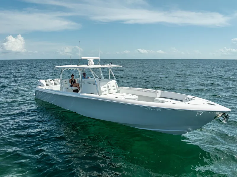 Slide: The Image of 2025 Contender 44 ST boat cruising on open ocean under clear blue sky. - 2