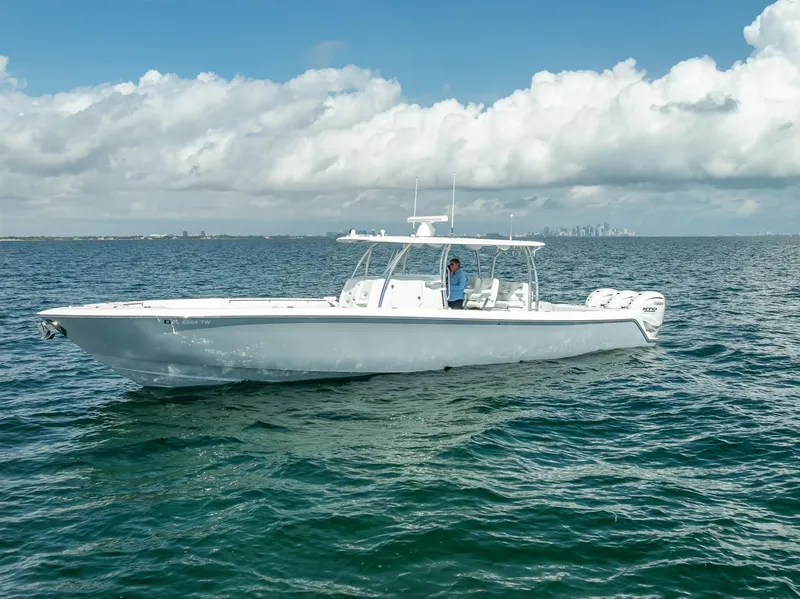 Slide: The Image of 2025 Contender 44 ST boat on open water under cloudy sky. - 21