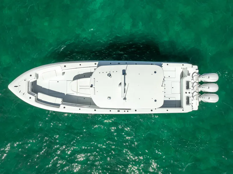 Slide: The Image of Aerial view of 2025 Contender 44 ST boat on turquoise water. - 22