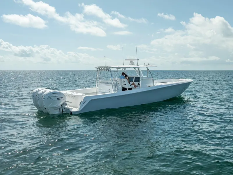 Slide: The Image of 2025 Contender 44 ST boat on open water under a clear sky. - 24