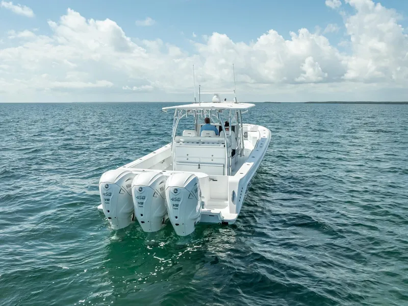 Slide: The Image of 2025 Contender 44 ST boat with triple engines cruising on open water. - 25