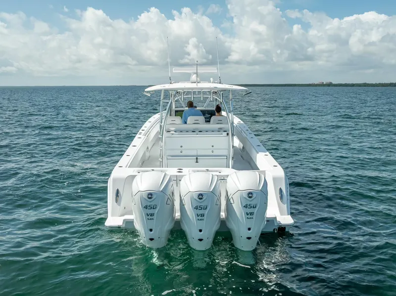 Slide: The Image of 2025 Contender 44 ST boat with triple 450 V8 engines on open water. - 27