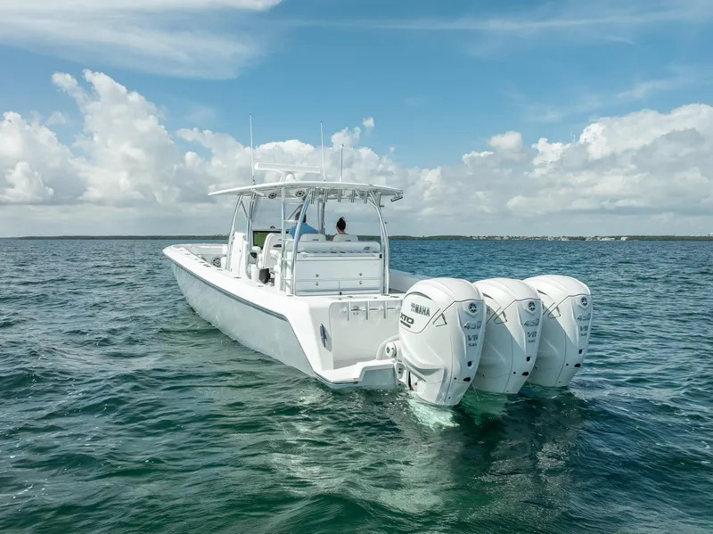 Slide: The Image of 2025 Contender 44 ST boat with triple outboard engines on open water. - 28