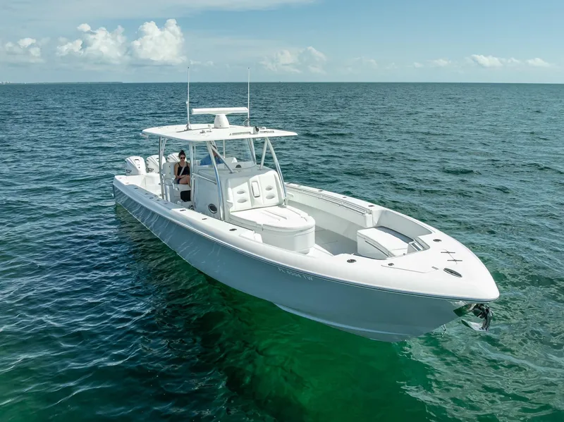 Slide: The Image of 2025 Contender 44 ST boat cruising on open sea under clear skies. - 3