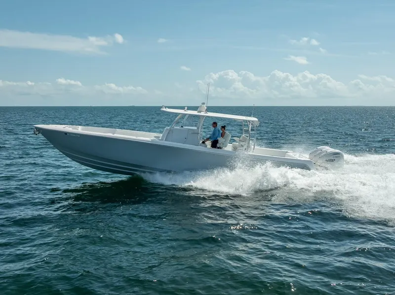 Slide: The Image of 2025 Contender 44 ST boat cruising on open water under clear skies. - 32