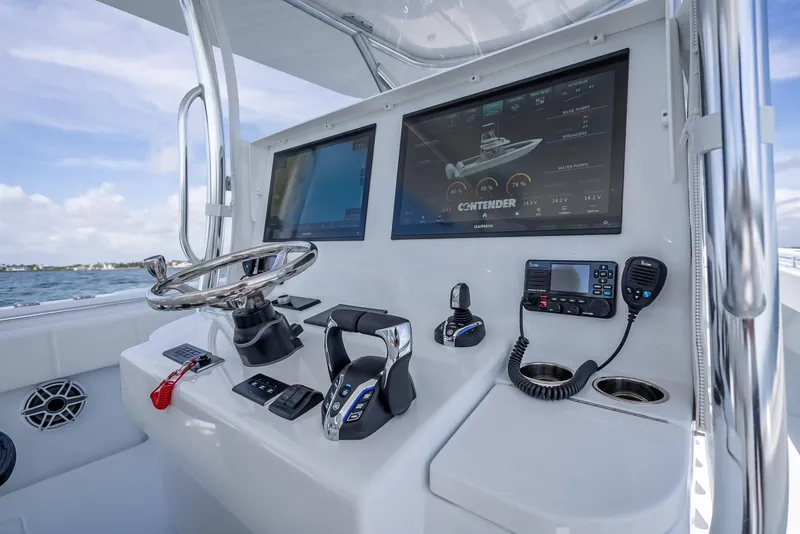 Slide: The Image of 2025 Contender 44 ST boat dashboard with dual screens and navigation controls. - 37