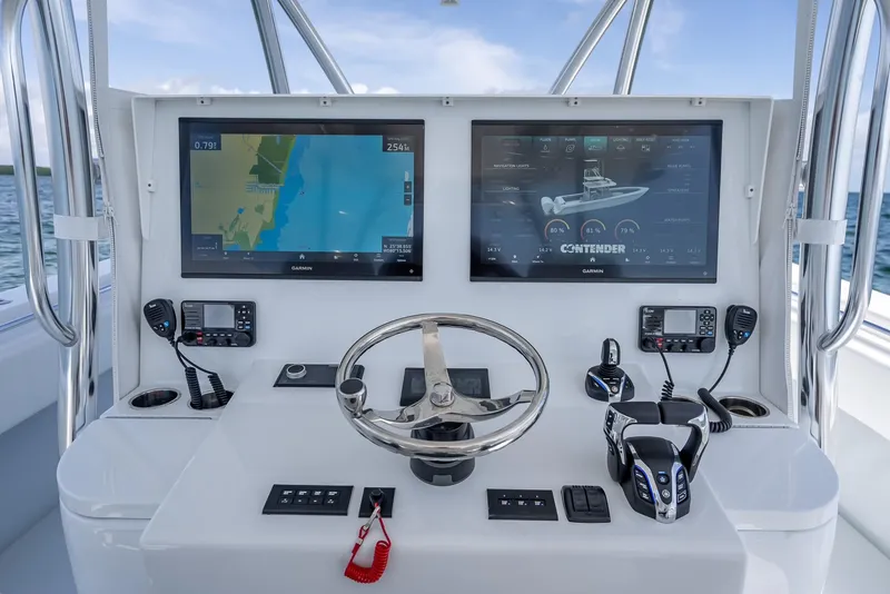 Slide: The Image of Helm of 2025 Contender 44 ST boat with dual navigation screens and controls. - 39