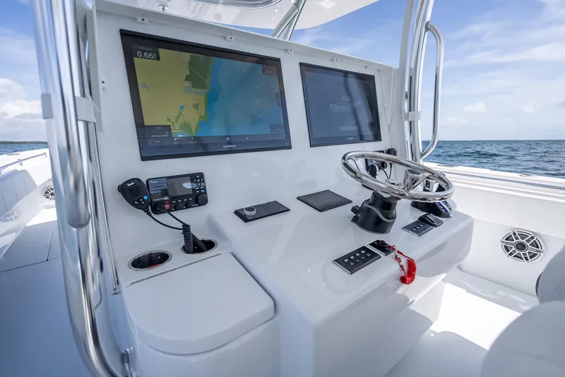 Slide: The Image of Helm of 2025 Contender 44 ST boat with dual screens and navigation controls. - 40