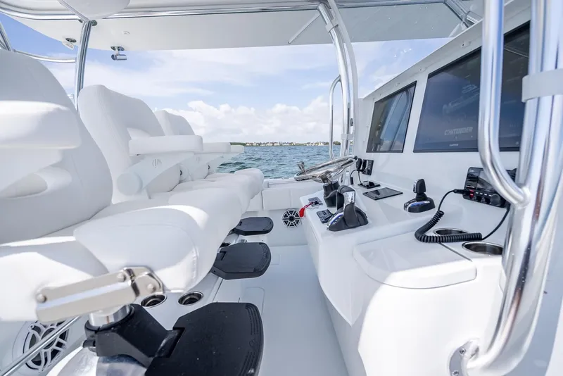 Slide: The Image of 2025 Contender 44 ST boat interior with white seating and modern controls. - 42