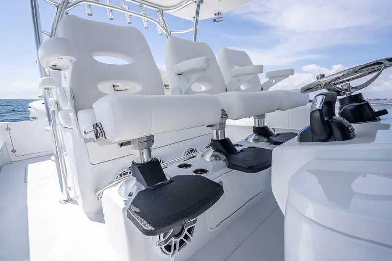 Slide: The Image of 2025 Contender 44 ST boat interior with white seating and steering wheel. - 44