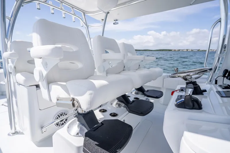 Slide: The Image of 2025 Contender 44 ST boat interior with white seating and ocean view. - 45