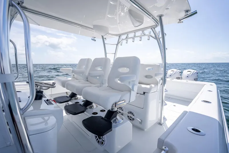 Slide: The Image of 2025 Contender 44 ST boat interior with white seating and ocean view. - 46