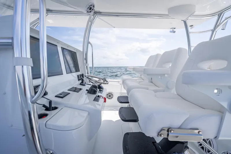 Slide: The Image of Interior of 2025 Contender 44 ST boat with modern controls and seating. - 48