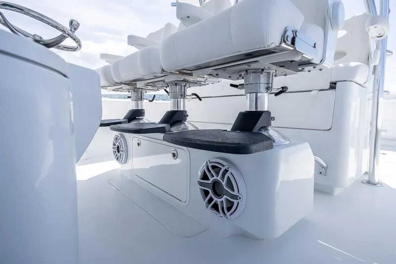 Slide: The Image of 2025 Contender 44 ST boat interior with white seating and built-in speakers. - 49