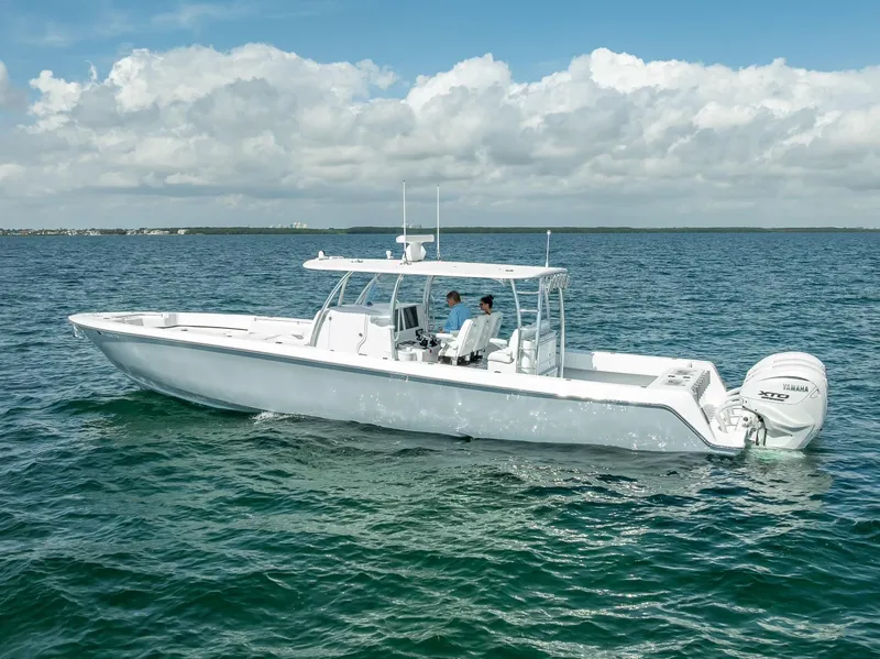 Slide: The Image of 2025 Contender 44 ST boat cruising on open water under a cloudy sky. - 6