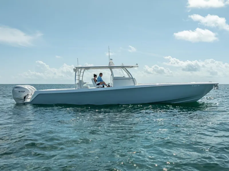 Slide: The Image of 2025 Contender 44 ST boat cruising on open water under a clear sky. - 7