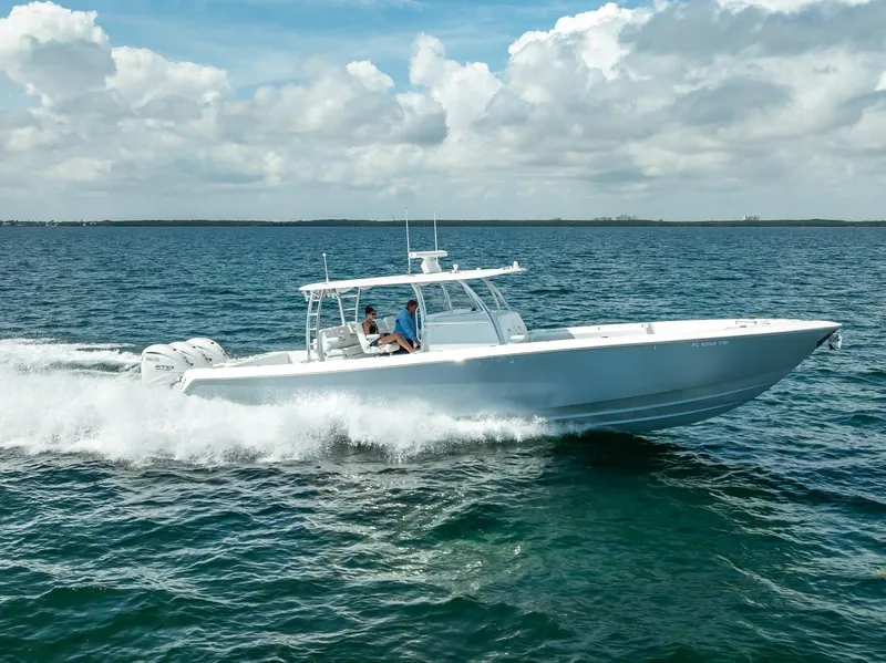 Slide: The Image of 2025 Contender 44 ST boat cruising on open water under a cloudy sky. - 8