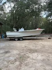 Slide: The Image of 2013 ENVI 25 Offshore Center Console boat on trailer, surrounded by trees. - 18