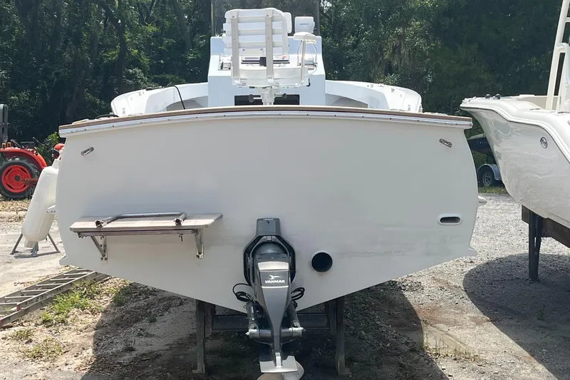 Slide: The Image of 2013 ENVI 25 Offshore Center Console boat, rear view, on a trailer in a yard. - 9