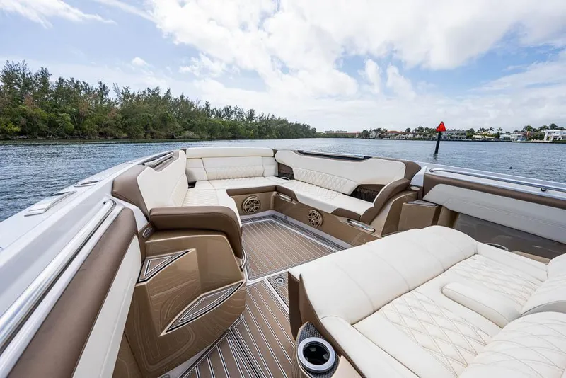Slide: The Image of Luxurious seating on 2019 Nor-Tech 450 Sport Center Console boat, with scenic water view. - 12