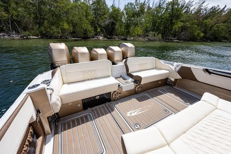 Slide: The Image of 2019 Nor-Tech 450 Sport Center Console boat with luxurious seating and powerful engines. - 16