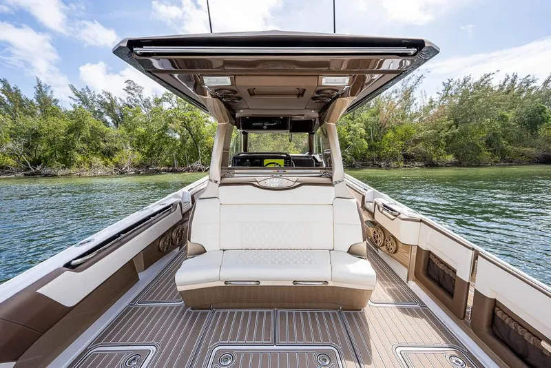 Slide: The Image of 2019 Nor-Tech 450 Sport Center Console boat interior with luxurious seating and scenic water view. - 17