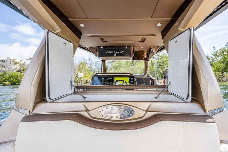 Slide: The Image of 2019 Nor-Tech 450 Sport Center Console interior with open storage compartments and navigation display. - 18