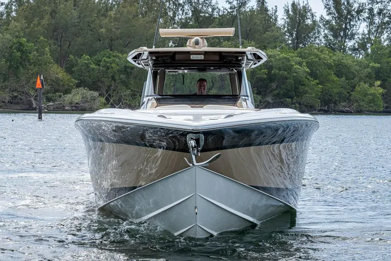 Slide: The Image of 2019 Nor-Tech 450 Sport Center Console boat on water, front view. - 2