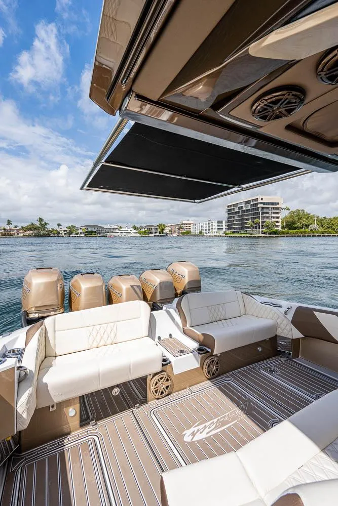 Slide: The Image of 2019 Nor-Tech 450 Sport Center Console boat with luxurious seating and scenic waterfront view. - 20