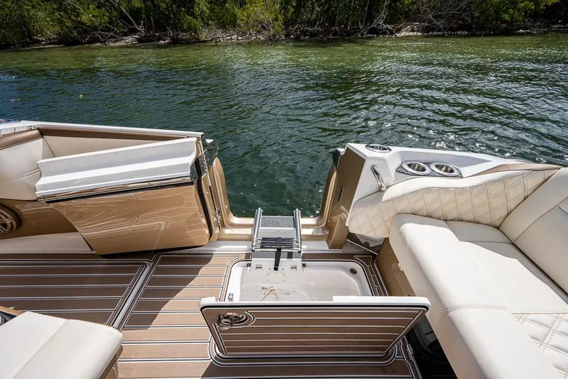Slide: The Image of 2019 Nor-Tech 450 Sport Center Console boat interior with luxurious seating and water view. - 21