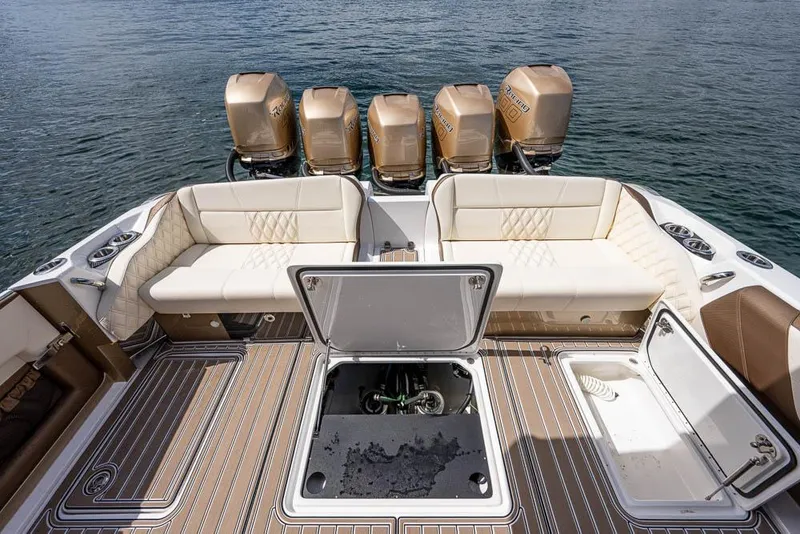 Slide: The Image of 2019 Nor-Tech 450 Sport Center Console boat with luxurious seating and powerful outboard engines. - 22