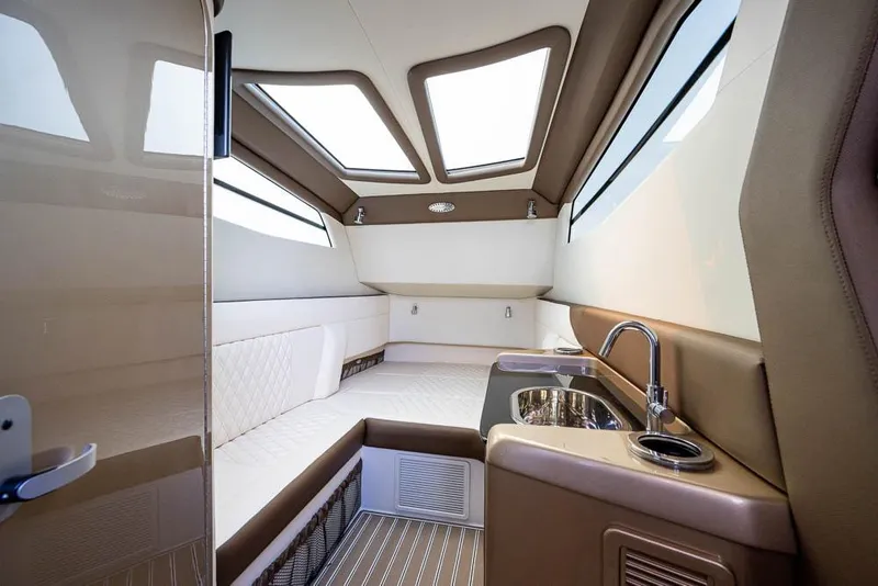 Slide: The Image of Luxurious interior of 2019 Nor-Tech 450 Sport Center Console with seating and kitchenette. - 24