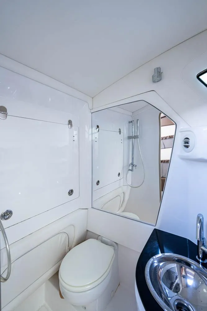 Slide: The Image of 2019 Nor-Tech 450 Sport Center Console bathroom with modern fixtures and sleek design. - 25