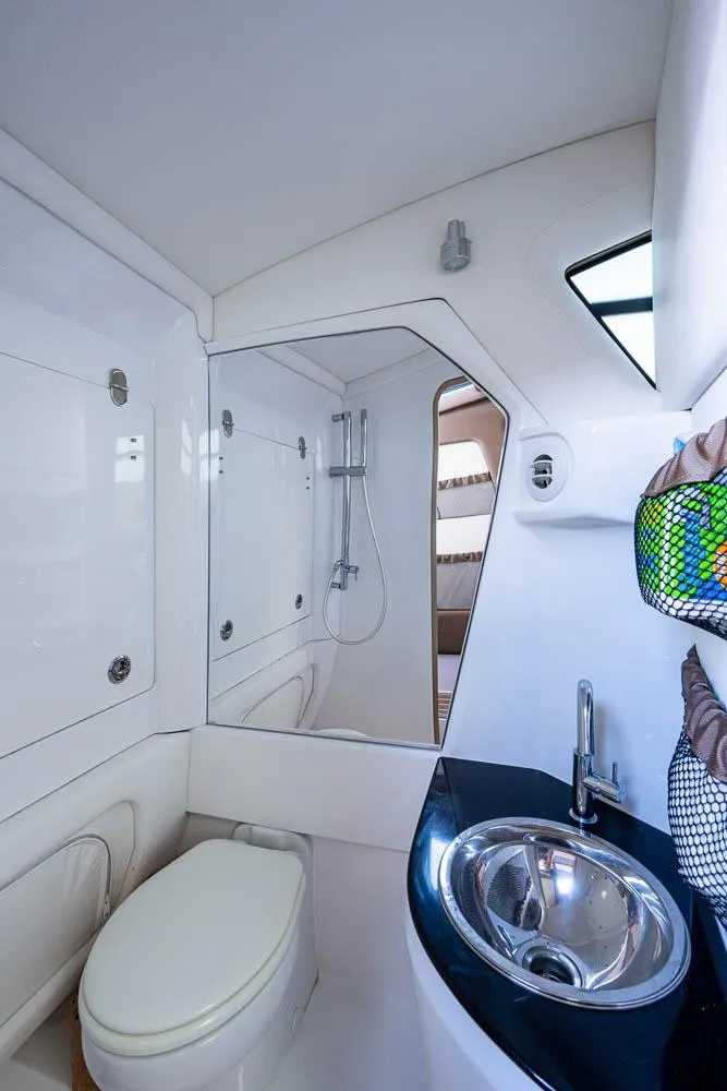 Slide: The Image of 2019 Nor-Tech 450 Sport Center Console bathroom with modern fixtures and sleek design. - 32