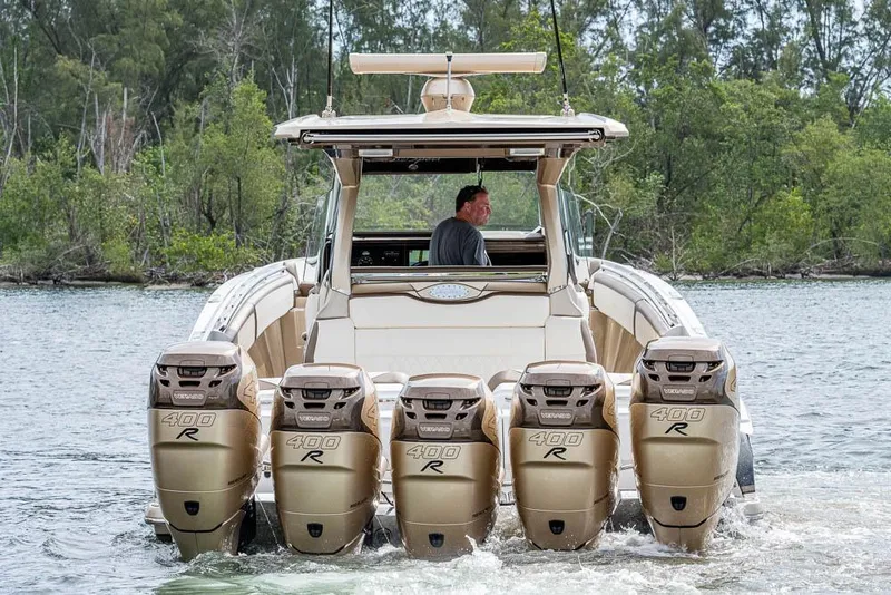 Slide: The Image of 2019 Nor-Tech 450 Sport Center Console with five powerful outboard engines on a scenic waterway. - 43