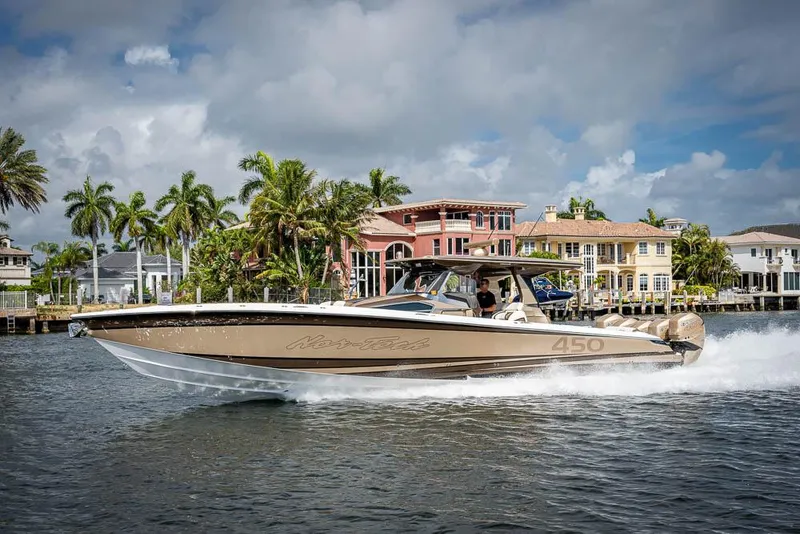 Slide: The Image of 2019 Nor-Tech 450 Sport Center Console cruising on a scenic waterway. - 47