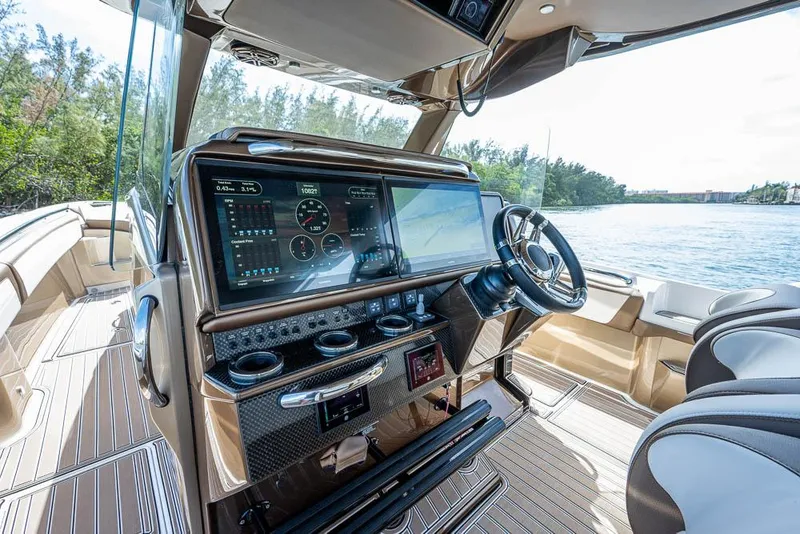 Slide: The Image of 2019 Nor-Tech 450 Sport Center Console boat interior with advanced navigation system. - 5