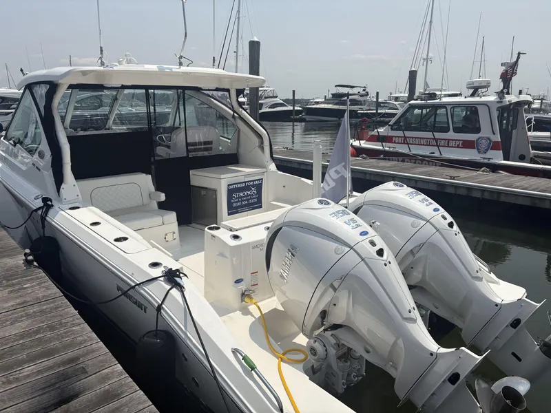 The Image of 2025 Pursuit DC 326 Dual Console boat on calm blue water. - 0