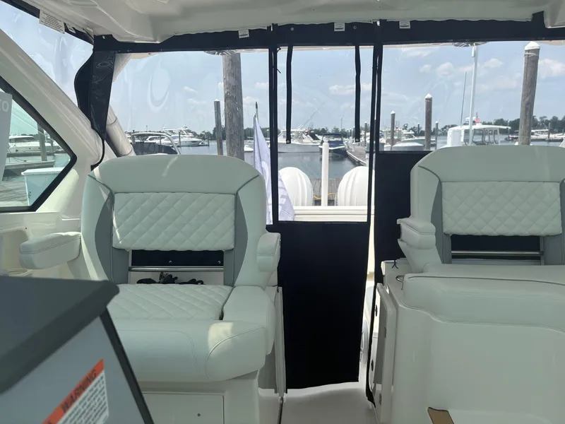 Slide: The Image of 2025 Pursuit DC 326 boat interior with storage compartments and sleek design. - 12