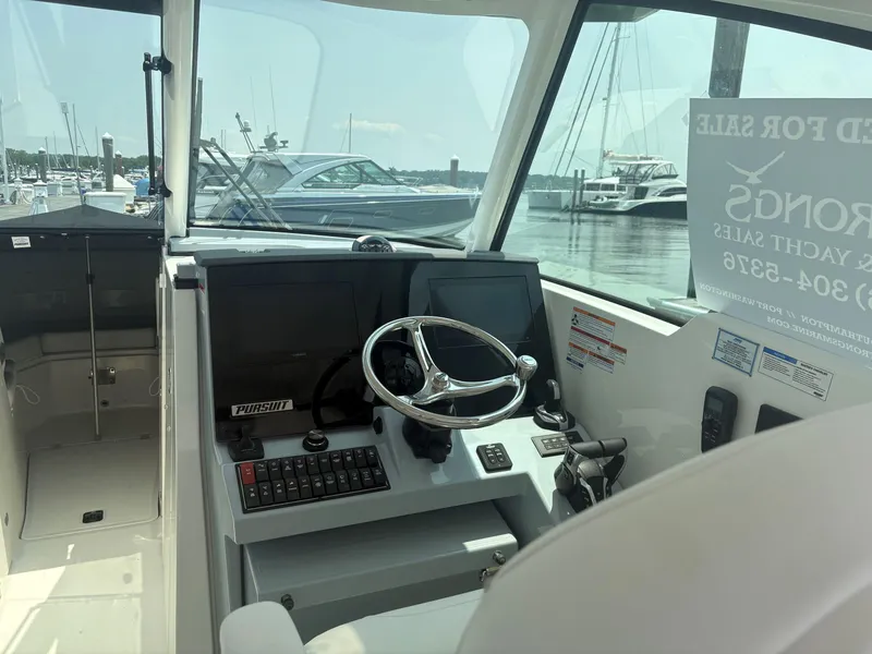 Slide: The Image of Open storage compartment on 2025 Pursuit DC 326 boat, showcasing interior space and design. - 13