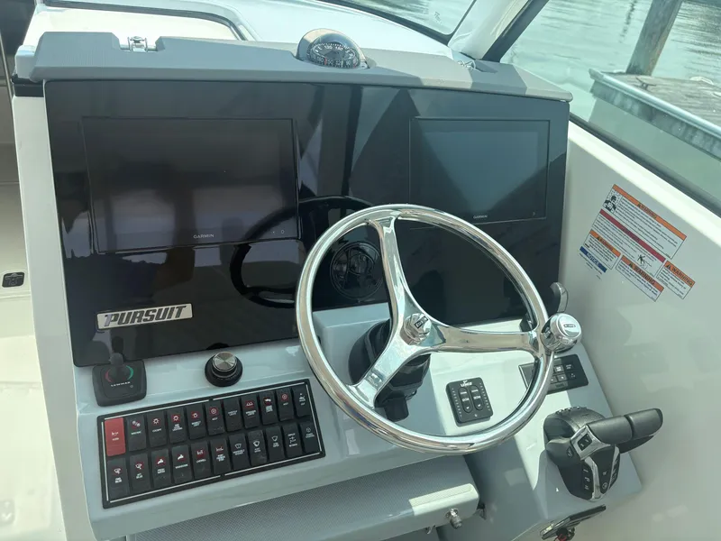 Slide: The Image of 2025 Pursuit DC 326 boat interior with sink and seating area. - 14