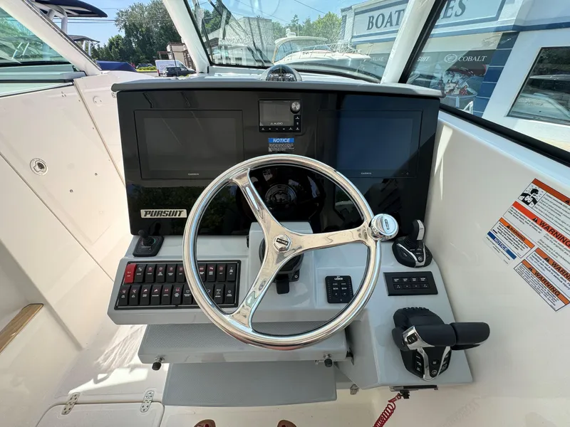 Slide: The Image of 2025 Pursuit DC 326 boat interior with open drawer and sink. - 15