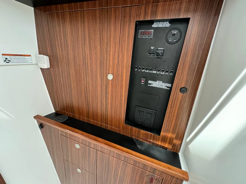 Slide: The Image of 2025 Pursuit DC 326 boat dashboard with steering wheel and control panel. - 20