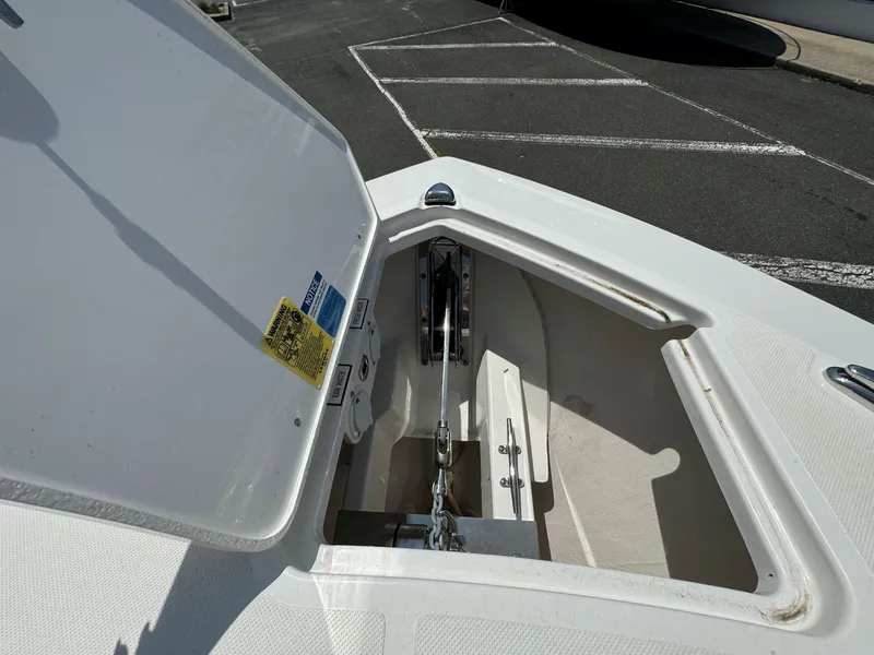 Slide: The Image of Interior of 2025 Pursuit DC 326 boat with white seating and marina view. - 22