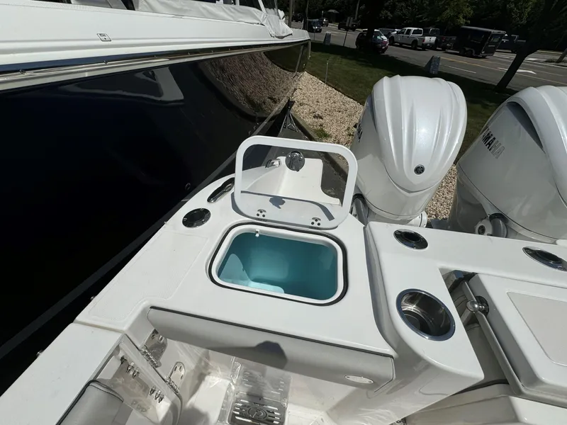 Slide: The Image of 2025 Pursuit DC 326 Dual Console boat on calm water. - 3