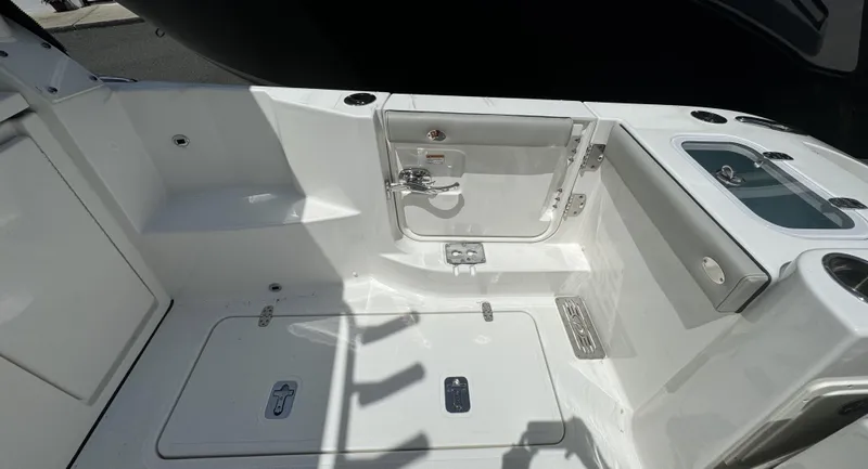 Slide: The Image of 2025 Pursuit DC 326 boat docked with twin engines, marina background. - 7